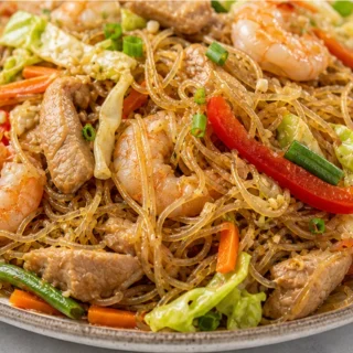 Filipino Pancit Noodles Recipe - Discover the ultimate Filipino Pancit recipe! Easy to make with tender noodles, savory pork, shrimp, and vibrant veggies. A del