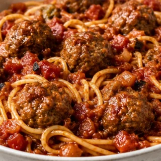Chili Meatballs & Spaghetti: Your Crockpot Comfort! Chili Meatballs: Savor juicy ground beef meatballs simmered in a rich, smoky sauce with tender spaghetti, al