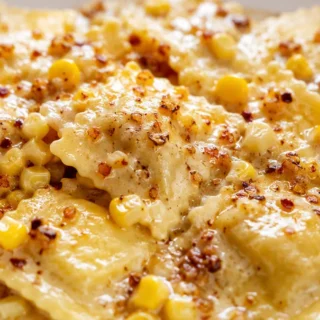 Browned Garlic Butter Creamed Corn Ravioli - Creamed corn ravioli: savor this rich and flavorful pasta dish with browned garlic butter and fresh thyme. A quick