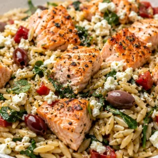 Zesty Greek Salmon & Feta Orzo - Greek salmon: prepare this vibrant, healthy meal featuring flaky salmon, tangy lemon feta, and a refreshing orzo summer salad.