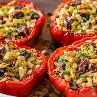 ️ Greek Orzo Stuffed Peppers! Stuffed peppers: savor these Greek Orzo Stuffed Red Peppers with a vibrant lemony basil tomato topping. A healthy and flavorful me