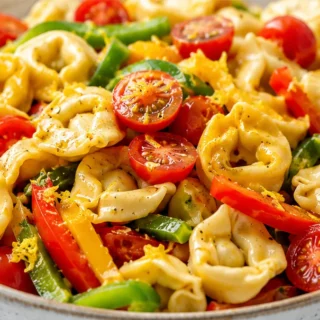 Zesty Tortellini Pasta Salad - tortellini salad - Tortellini salad: whip up this vibrant Italian dish with bell peppers and a zesty dressing. Perfect for a quic