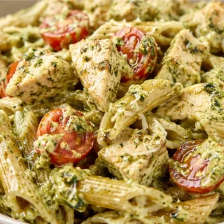 Creamy Pesto Chicken Pasta Salad - Pesto chicken: savor this creamy pasta salad with grilled chicken, avocado, and crispy bacon. Perfect for a quick, flavorful