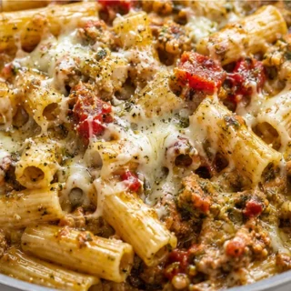 Cheesy Pesto Rigatoni: One-Pot Wonder! Pesto Rigatoni: enjoy this spicy one-pot baked pasta with chicken sausage. A comforting, cheesy meal ready for weeknights