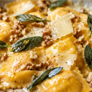 Creamy Pumpkin Ravioli with Crispy Sage! Pumpkin ravioli: master this luxurious sage butter sauce with crispy walnuts. Quick, flavorful, and perfect for a cozy