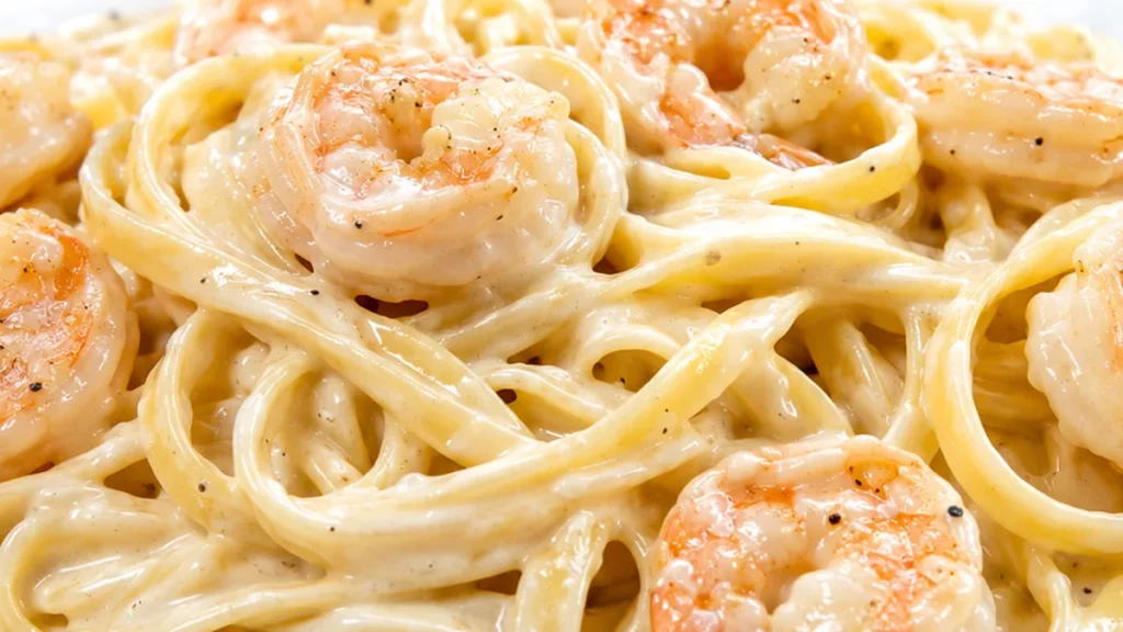 Creamy Shrimp Alfredo - Make delicious shrimp alfredo pasta in under 30 minutes! This easy recipe features succulent shrimp and a rich, creamy sauce coating fet
