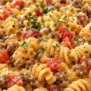 Cheesy Skillet Queso Pasta - Queso pasta: whip up this incredibly cheesy and easy skillet recipe in under 30 minutes. Loaded with seasoned beef and Rotel, it's